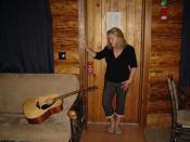 bobbi schram on mini vacation in log cabin with guitar. Thinking up lyricis.